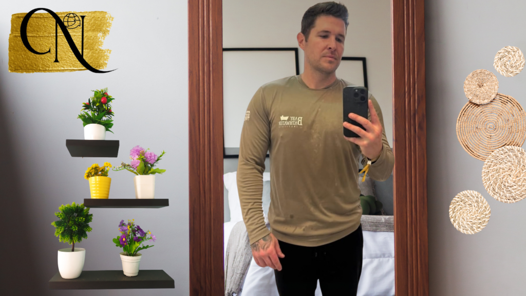 Photo Nick Eubanks taking selfie in the mirror of bedroom and wall is decorated by pots of plants